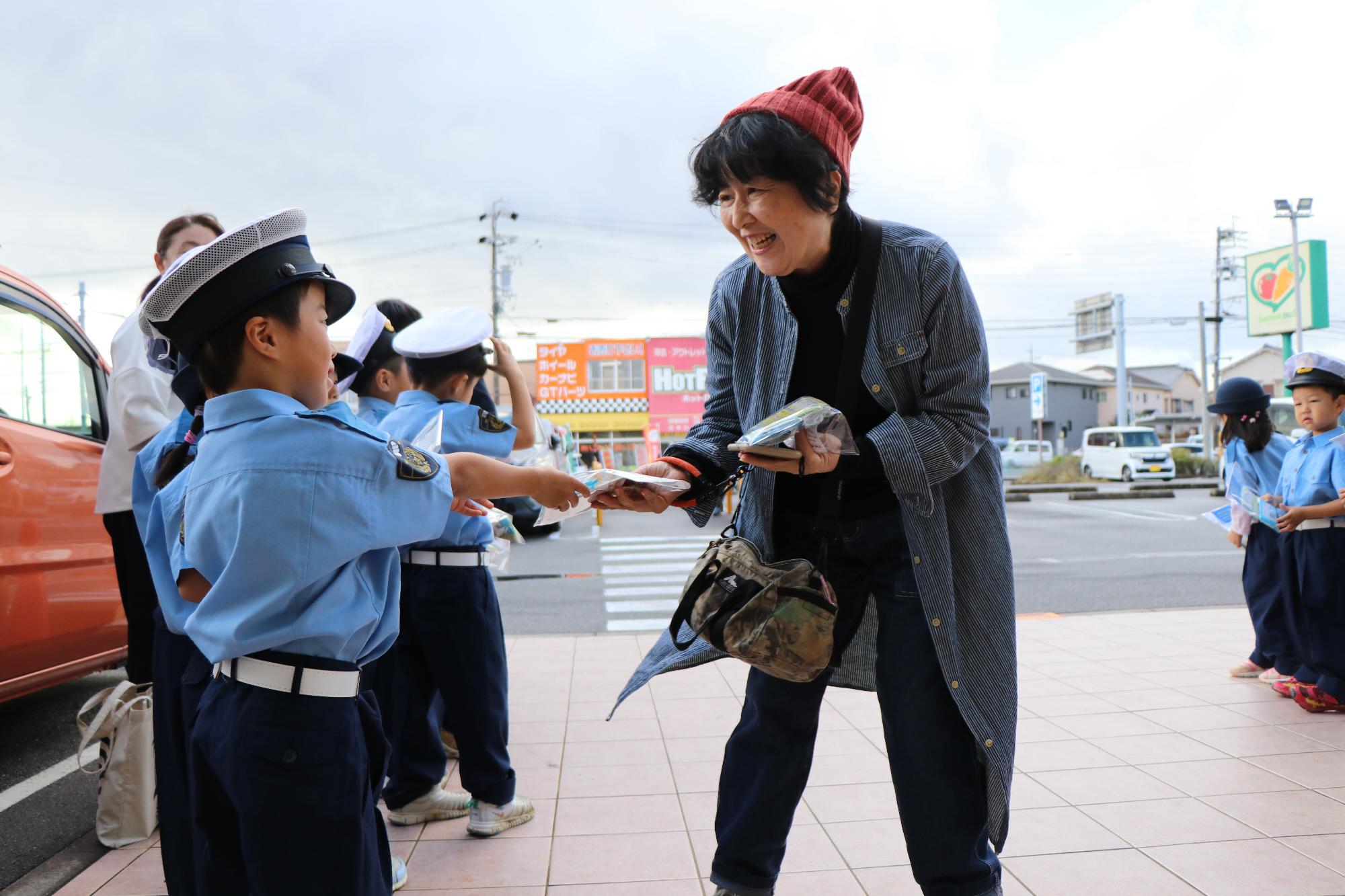 ハンドアップキャンペーン（笑顔で啓発品を受け取るお客さん）