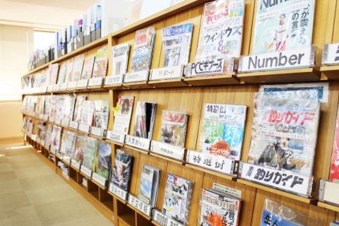 図書館の雑誌コーナーの棚に趣味など様々なジャンルの雑誌が並んでいる写真